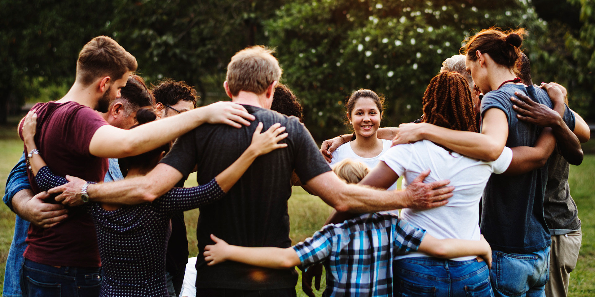 people in a circle with their arms around each other